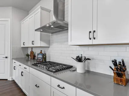 a kitchen with stainless steel appliances kitchen island granite countertop a sink stove and cabinets