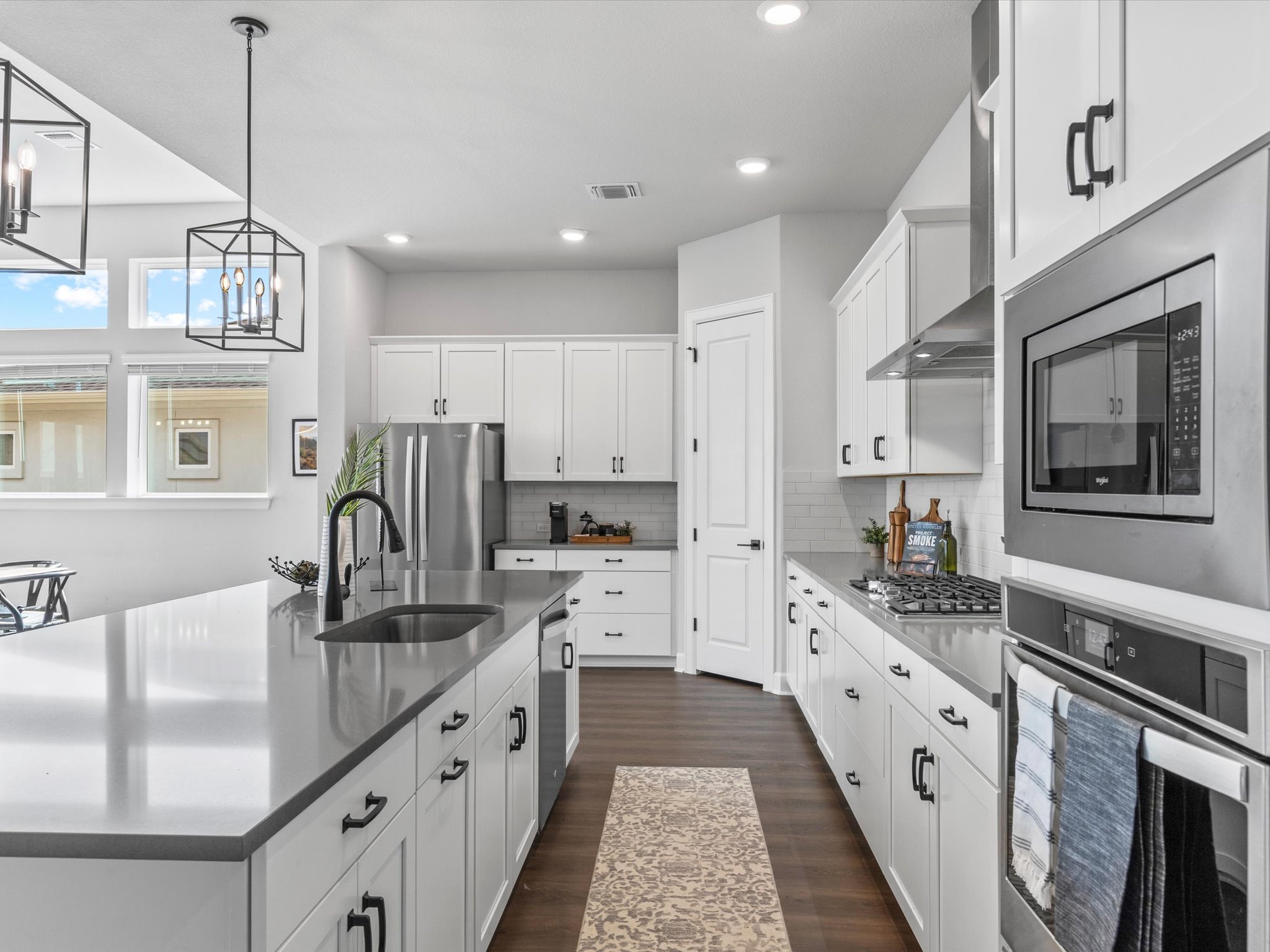 9001 Centurion Path Austin, TX 78744 - Photo 8 of 40 a kitchen with stainless steel appliances kitchen island granite countertop a sink stove and cabinets