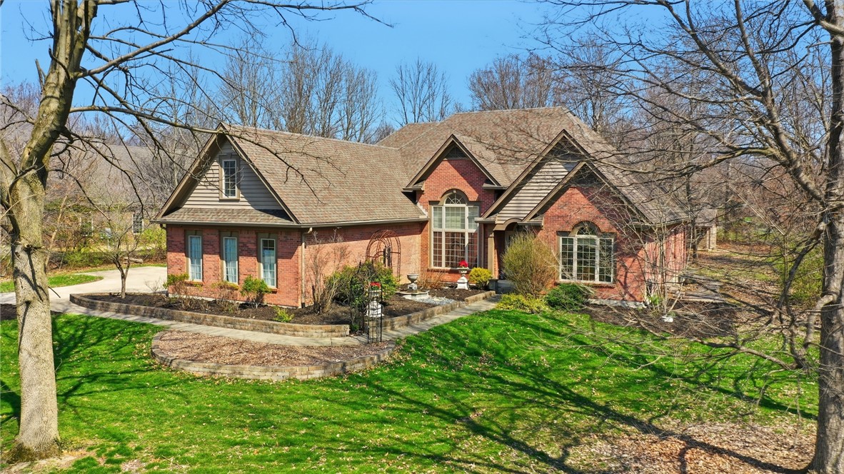 472 Timber Walk Court Springboro, OH 45066 - Photo 53 of 86 This classic brick residence presents a welcoming facade with a well-maintained lawn and mature trees.