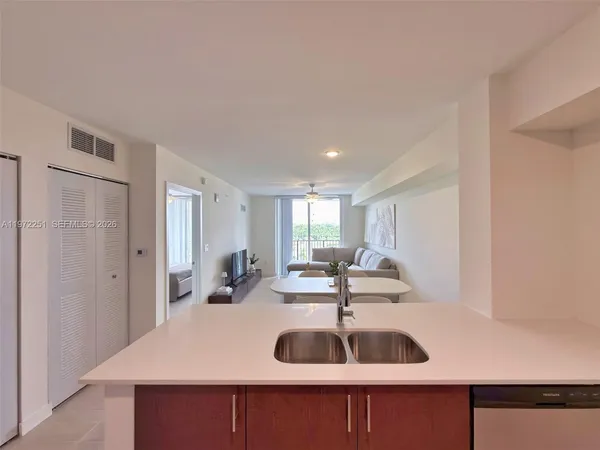 a kitchen with stainless steel appliances granite countertop a refrigerator stove and microwave