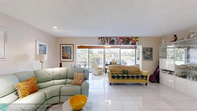 a living room with furniture and large windows