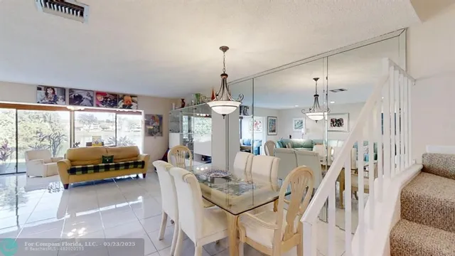 a living room with furniture a flat screen tv and a large window