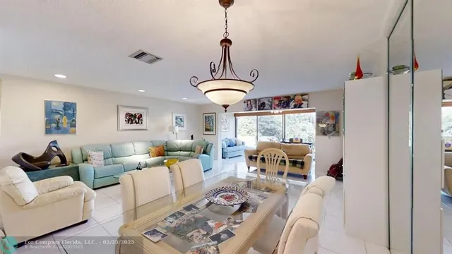 a living room with furniture a rug and white walls