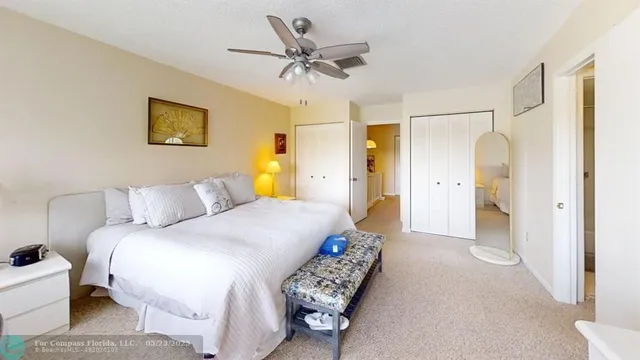 a spacious bedroom with a bed and a flat screen tv