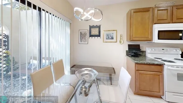 a view of a dining room with furniture and a flat screen tv