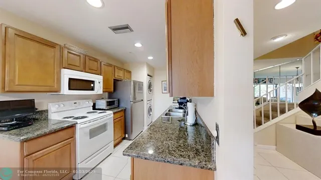 a kitchen with a sink stove and refrigerator