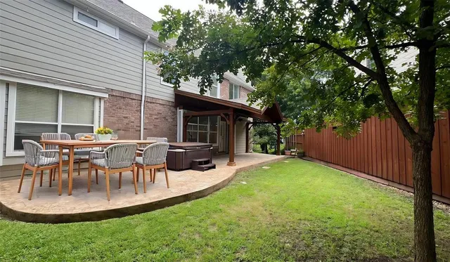 a backyard of a house with a garden and barbeque oven