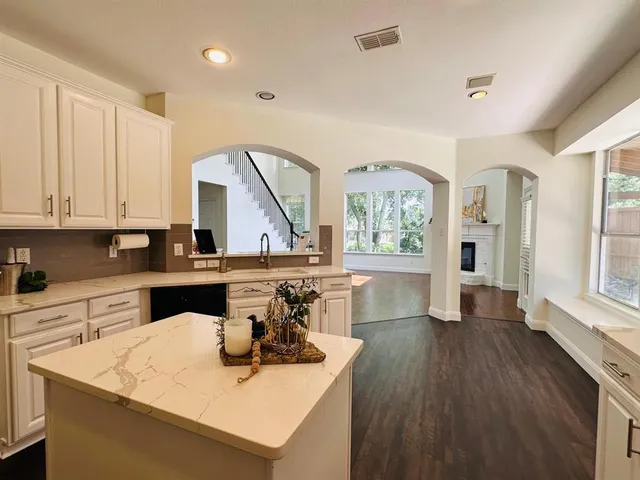 a kitchen with a sink a stove and cabinets