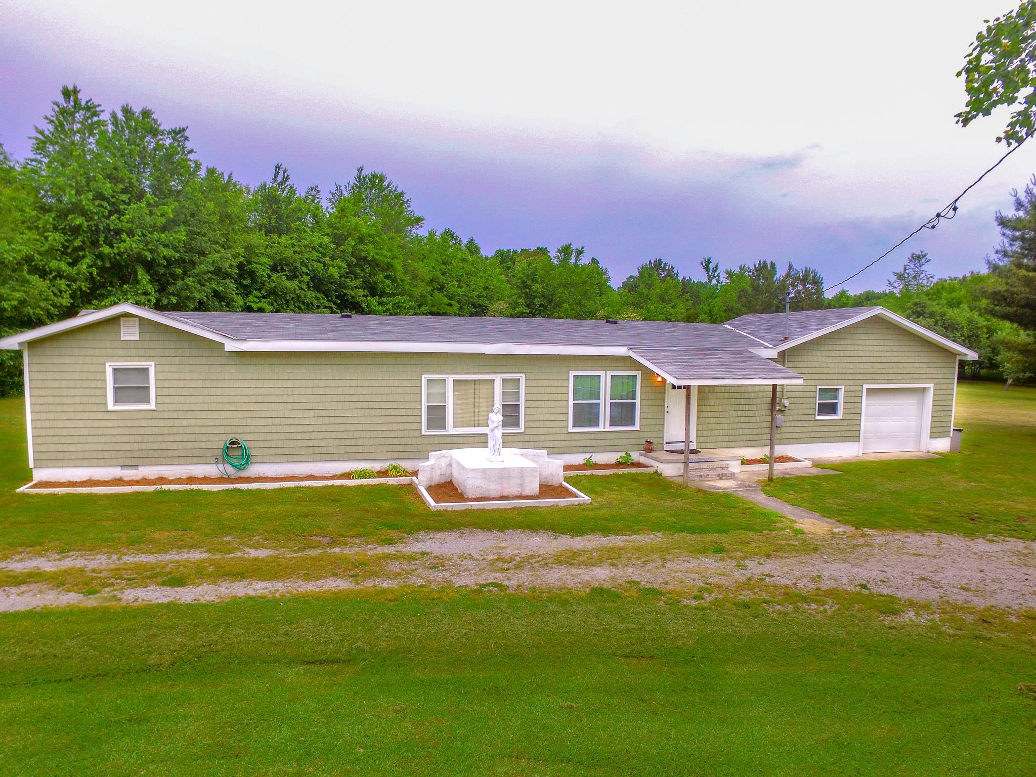 3955 Asbury Road Manchester, TN 37355 - Photo 1 of 19 a front view of a house with yard and green space