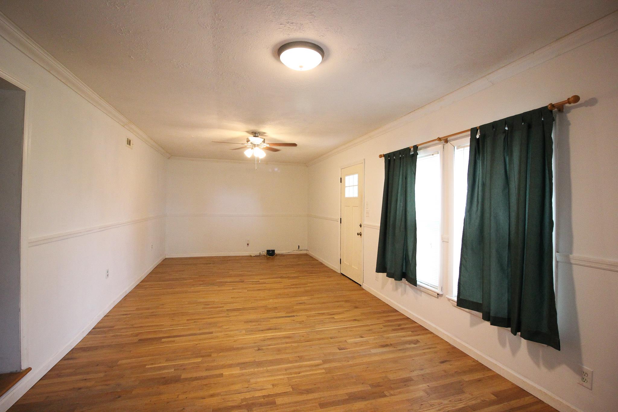 3955 Asbury Road Manchester, TN 37355 - Photo 4 of 19 wooden floor in an empty room with a window