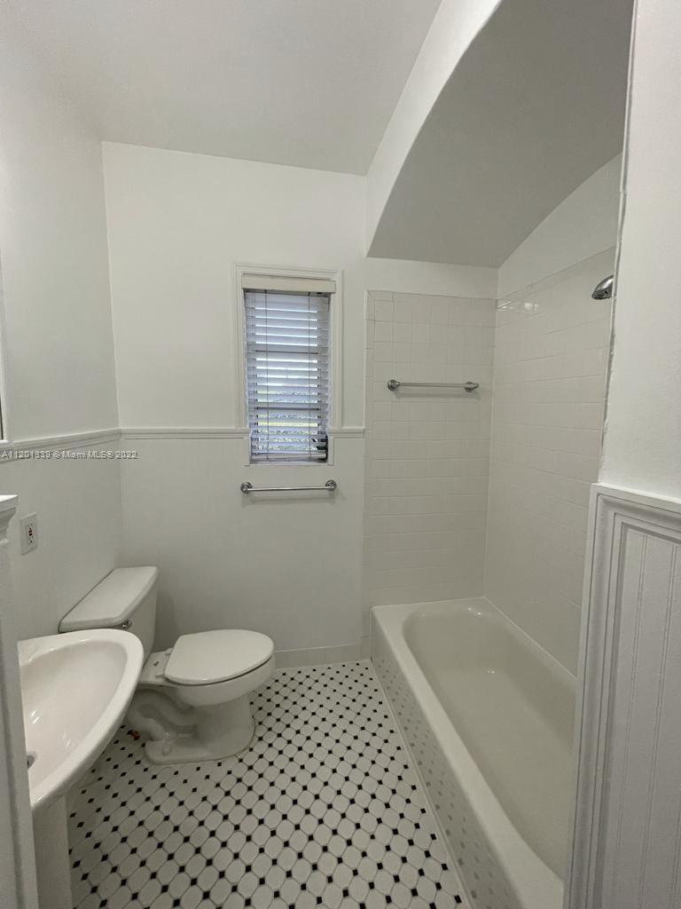 501 Southwest 24th Road Miami, FL 33129 - Photo 13 of 25 a bathroom with a sink a toilet a shower and a bathtub