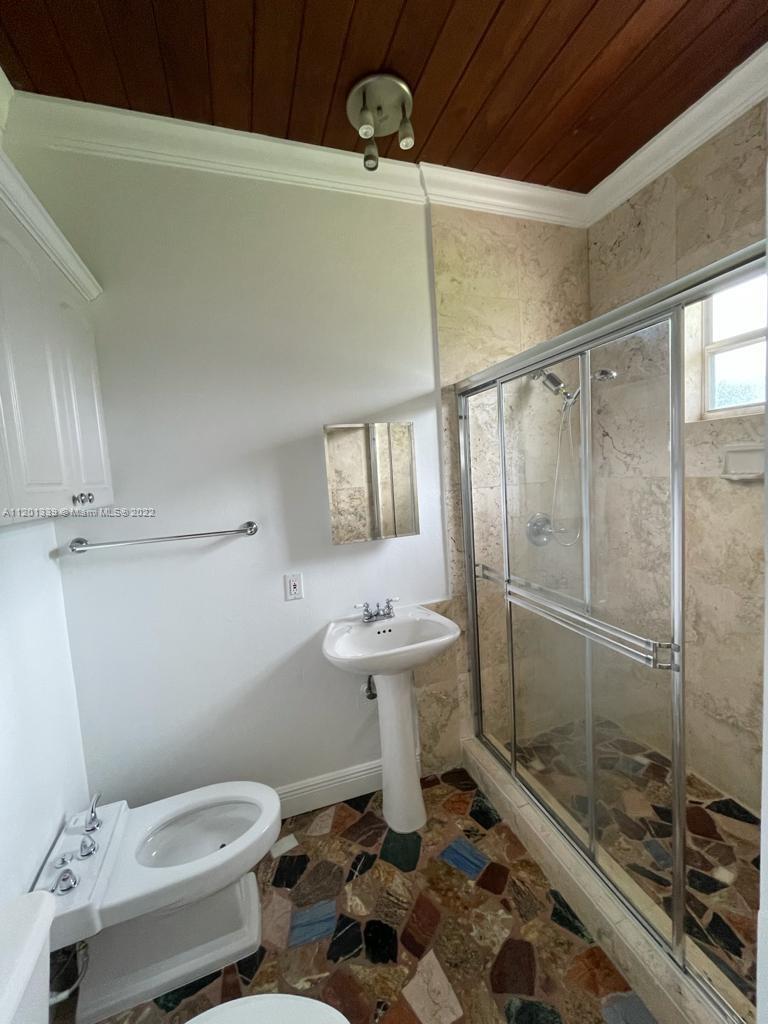 501 Southwest 24th Road Miami, FL 33129 - Photo 14 of 25 a bathroom with a sink a toilet and shower