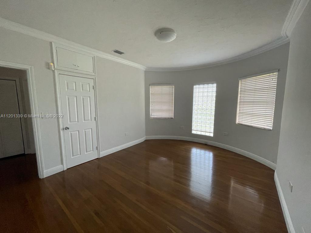 501 Southwest 24th Road Miami, FL 33129 - Photo 16 of 25 an empty room with wooden floor and windows