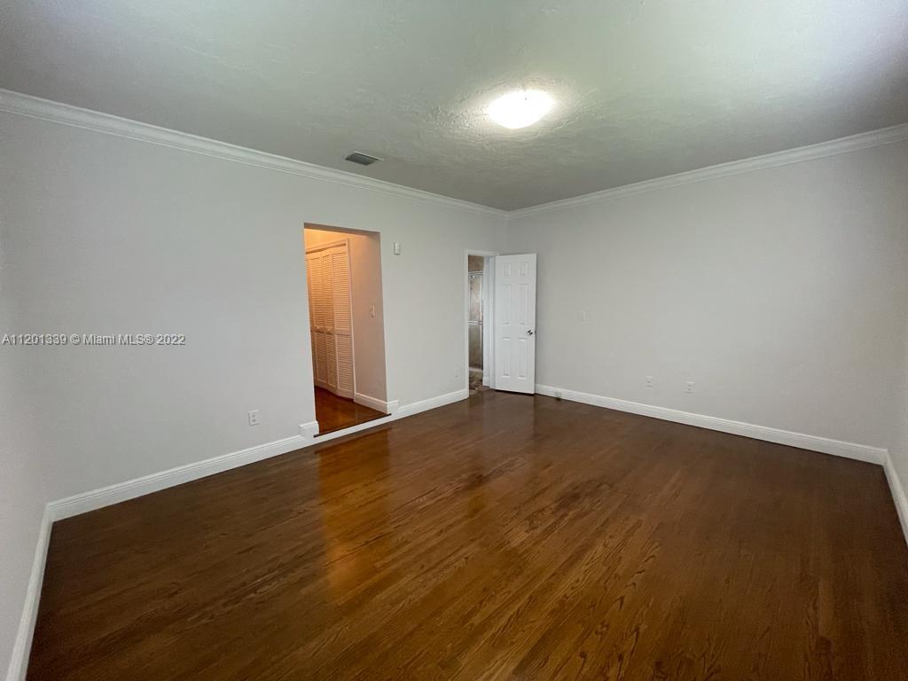 501 Southwest 24th Road Miami, FL 33129 - Photo 17 of 25 an empty room with wooden floor and windows