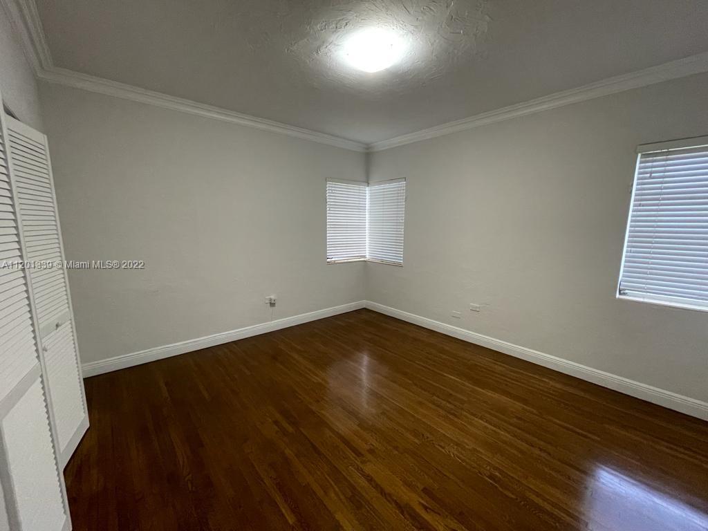 501 Southwest 24th Road Miami, FL 33129 - Photo 18 of 25 an empty room with wooden floor and windows