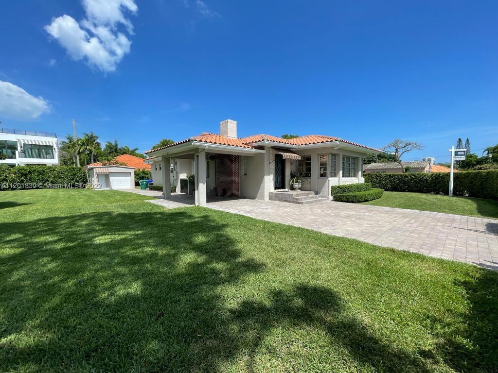 501 Southwest 24th Road Miami, FL 33129 - Photo 21 of 25 a front view of a house with a yard table and chairs