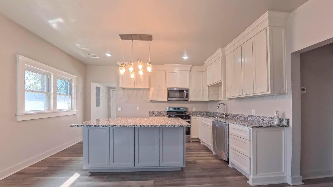 1316 Withers Avenue Amarillo, TX 79108 - Photo 13 of 19 a kitchen with a sink cabinets and window