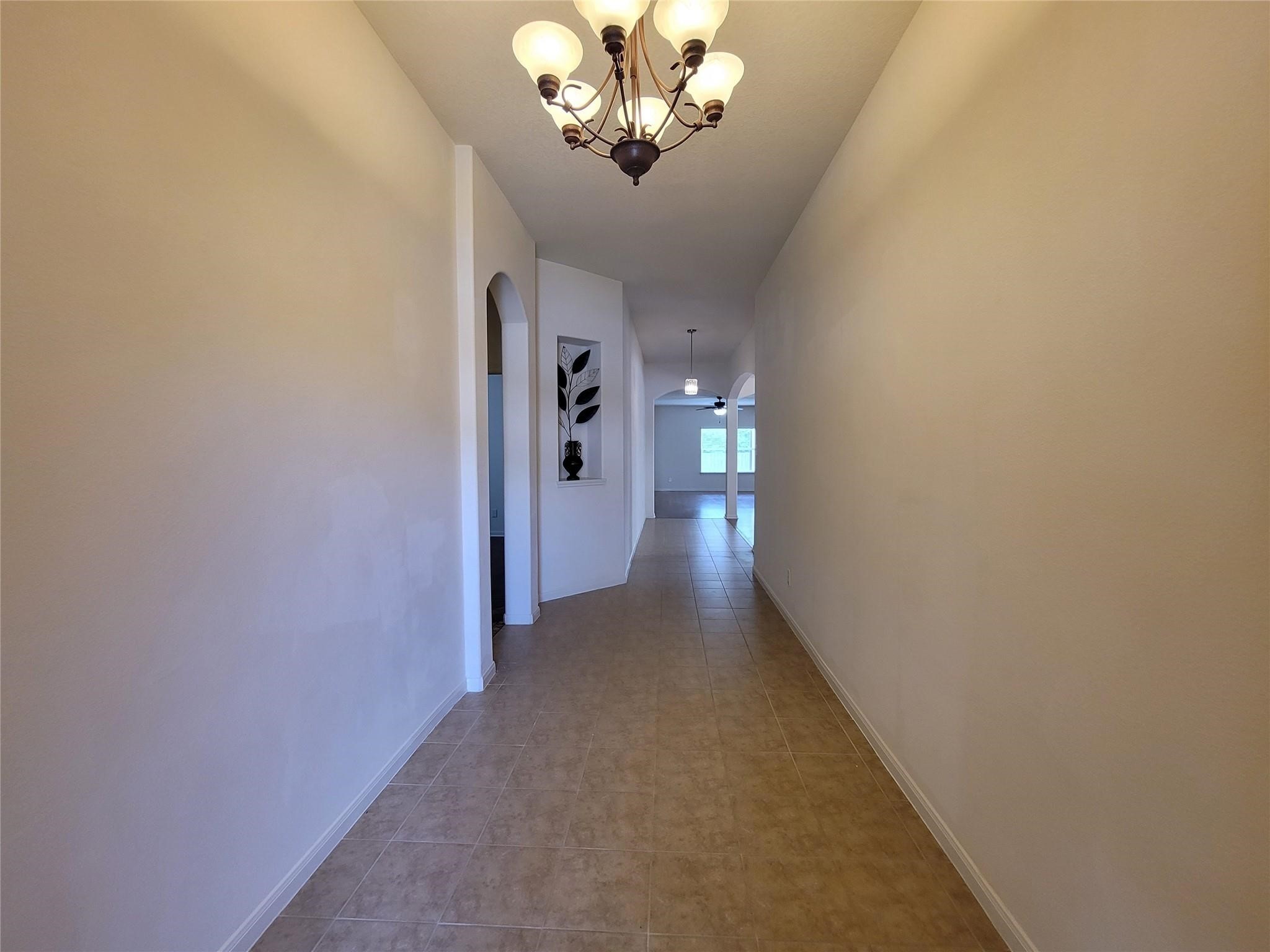 438 Oak Gate Drive Conroe, TX 77304 - Photo 3 of 18 a view of a hallway with a chandelier