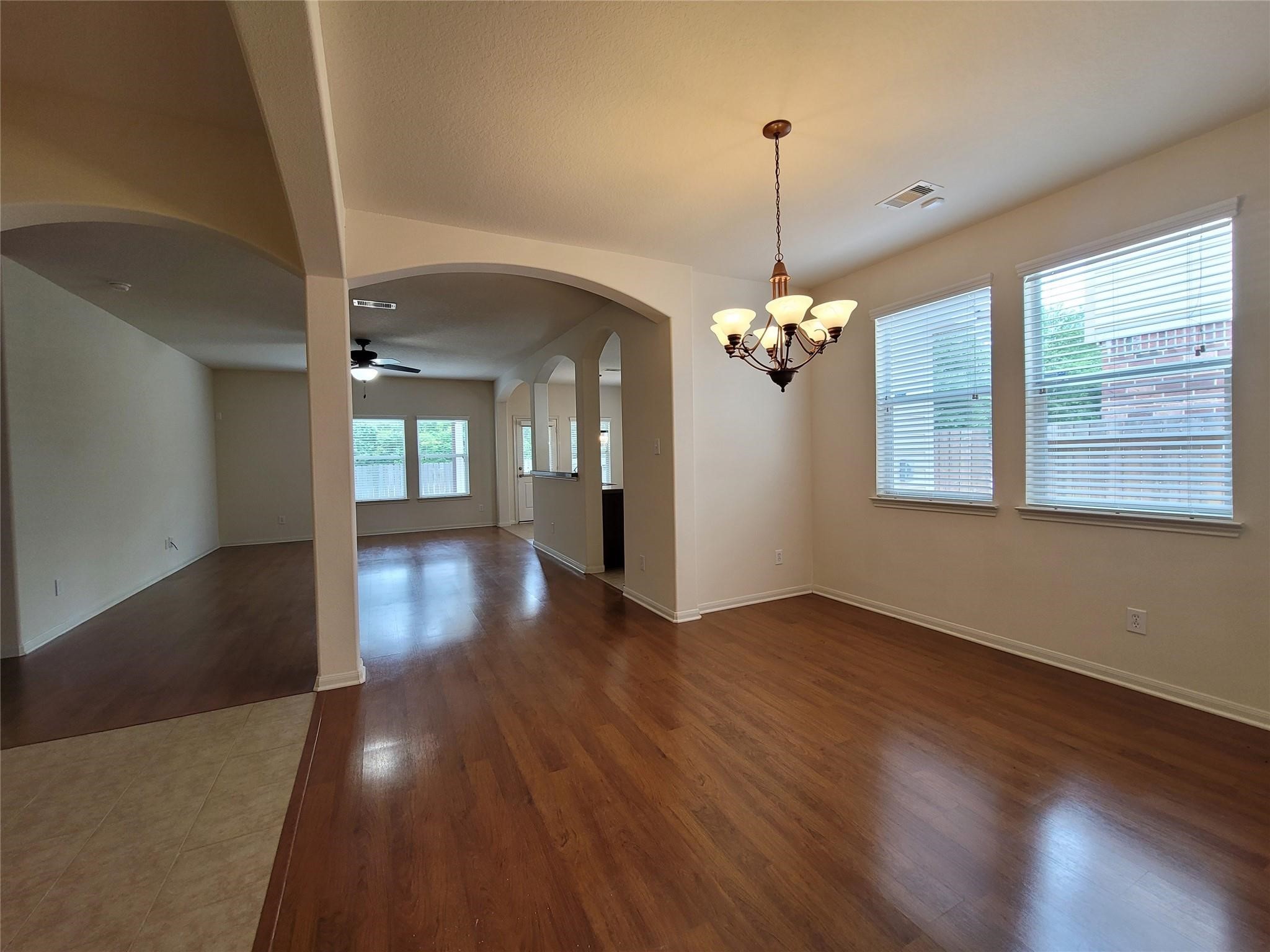 438 Oak Gate Drive Conroe, TX 77304 - Photo 4 of 18 a view of a room with wooden floor chandelier and windows