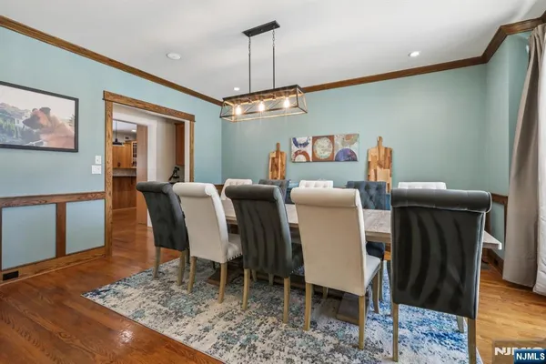 a large kitchen with stainless steel appliances granite countertop a lot of counter space and wooden floors