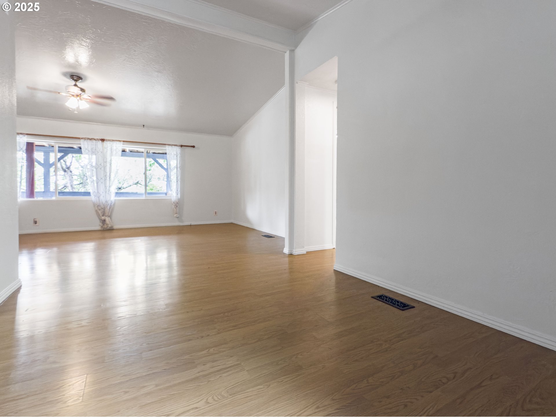 98041 Hallway Road, Unit 26 Brookings, OR 97415 - Photo 20 of 46 an empty room with wooden floor and windows