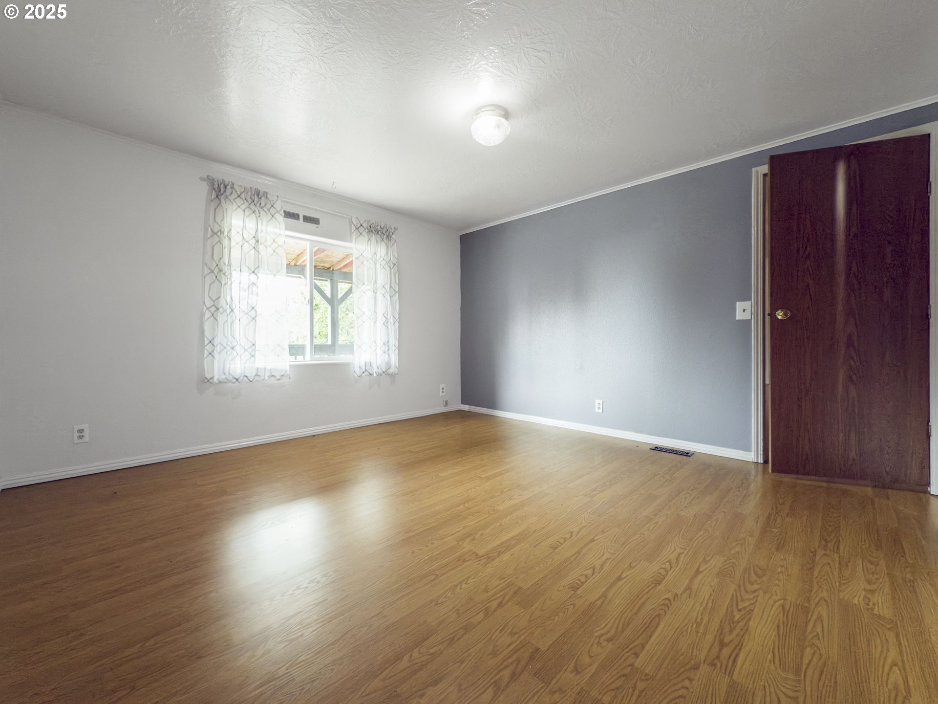 98041 Hallway Road, Unit 26 Brookings, OR 97415 - Photo 23 of 46 an empty room with wooden floor and windows