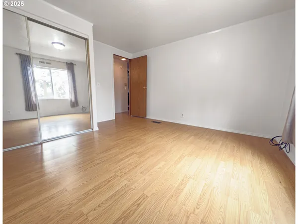 a view of an empty room and wooden floor