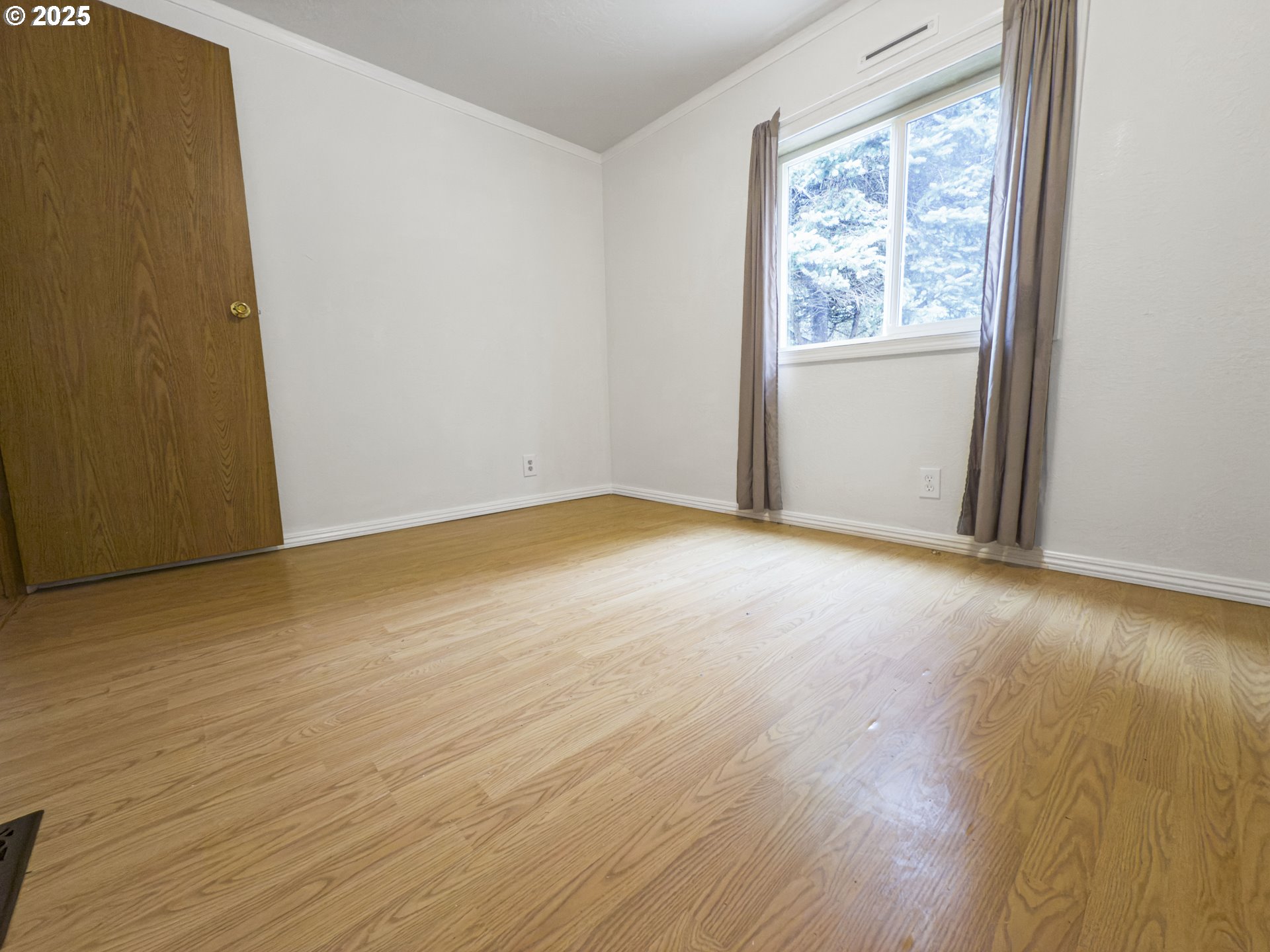 98041 Hallway Road, Unit 26 Brookings, OR 97415 - Photo 35 of 46 an empty room with wooden floor and windows