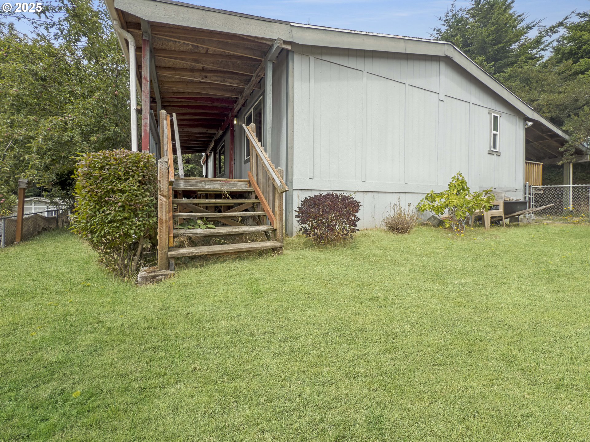 98041 Hallway Road, Unit 26 Brookings, OR 97415 - Photo 38 of 46 a view of a house with backyard and garden