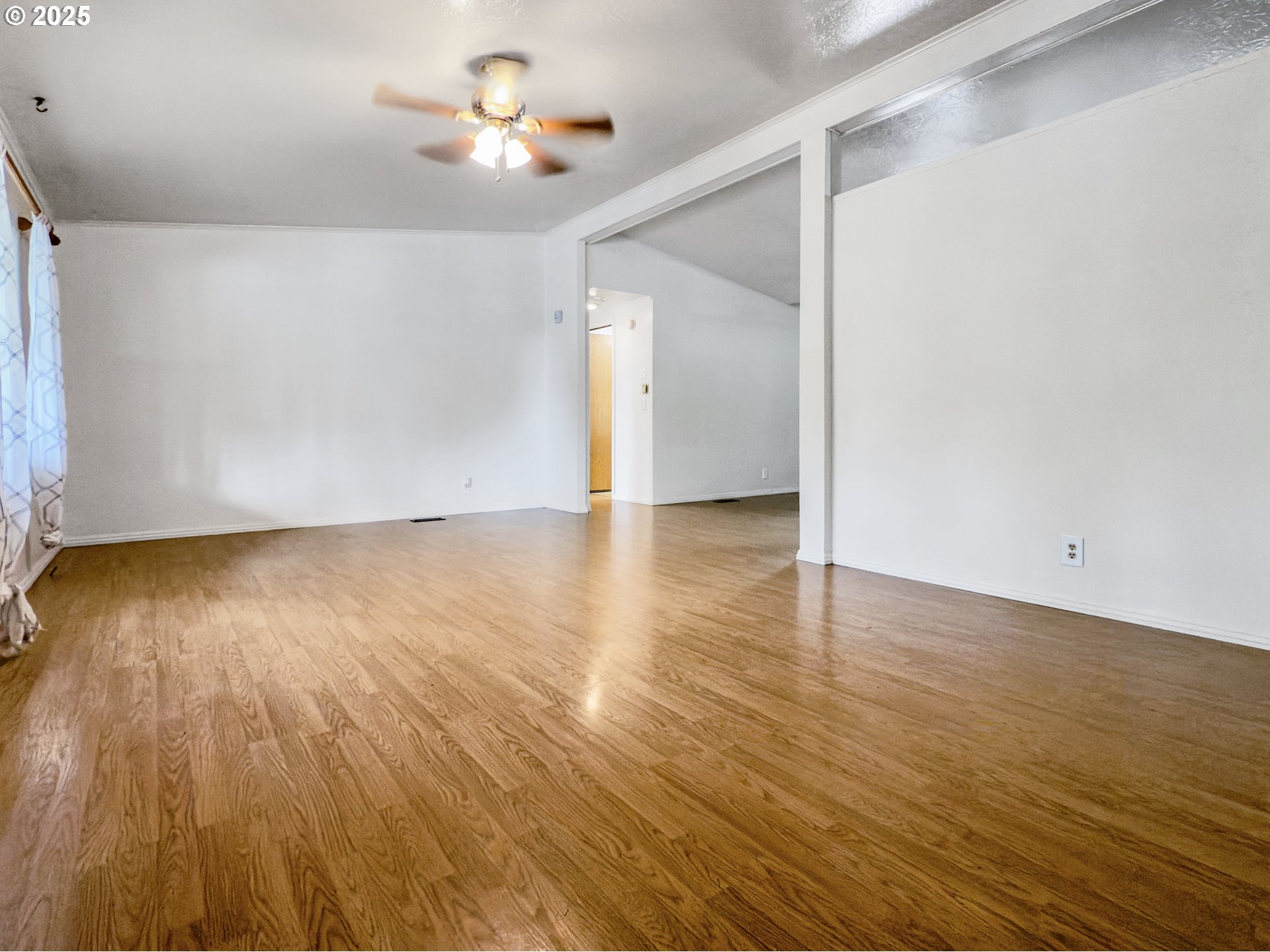 98041 Hallway Road, Unit 26 Brookings, OR 97415 - Photo 7 of 46 an empty room with wooden floor and windows