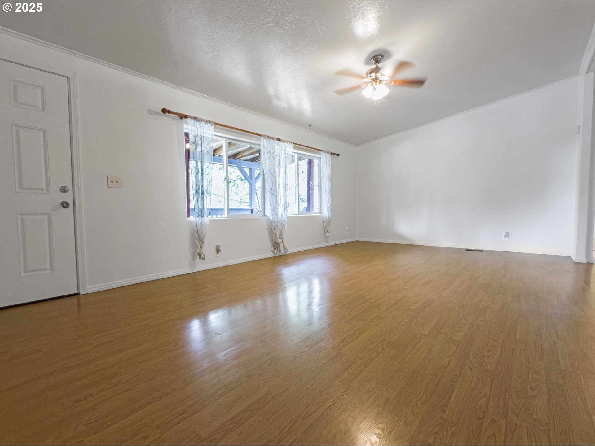 98041 Hallway Road, Unit 26 Brookings, OR 97415 - Photo 8 of 46 an empty room with wooden floor and windows