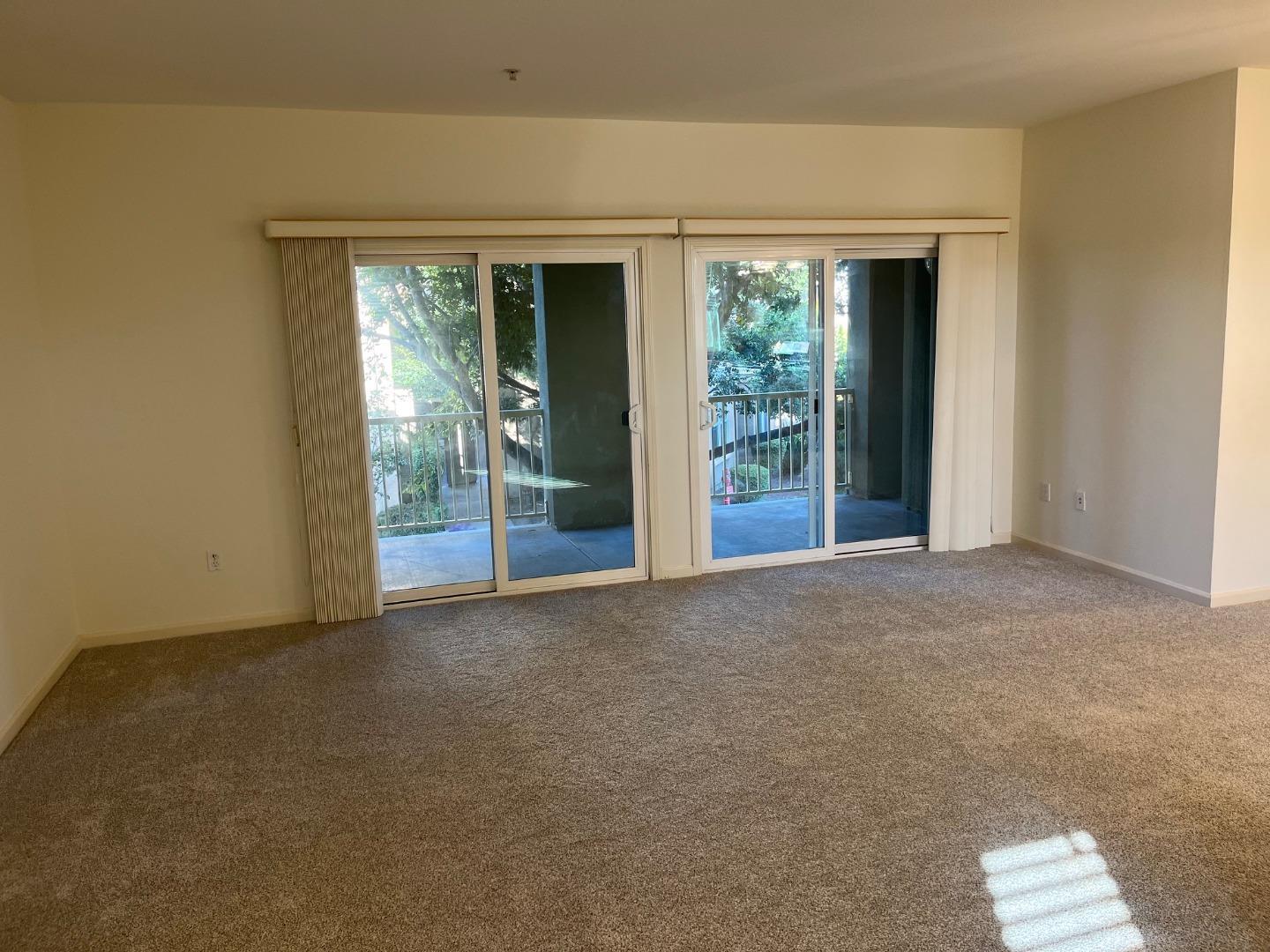 213 Pacifica Boulevard, Unit 202 Watsonville, CA 95076 - Photo 4 of 19 a view of an empty room with glass door