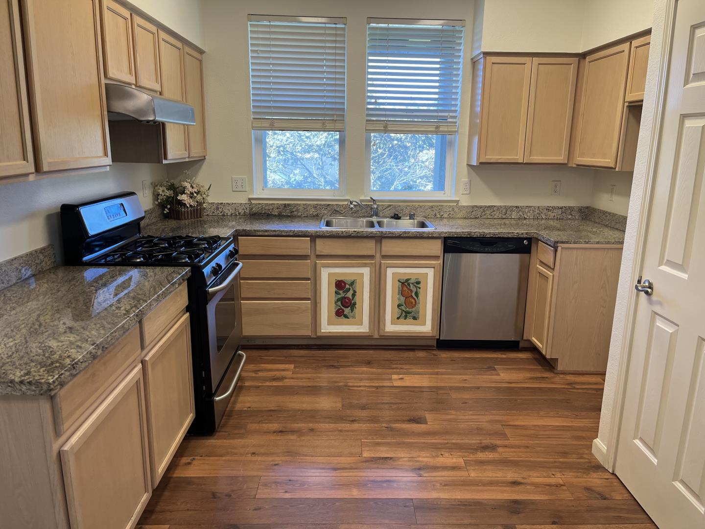 213 Pacifica Boulevard, Unit 202 Watsonville, CA 95076 - Photo 8 of 19 a kitchen with stainless steel appliances granite countertop a stove a sink and a microwave