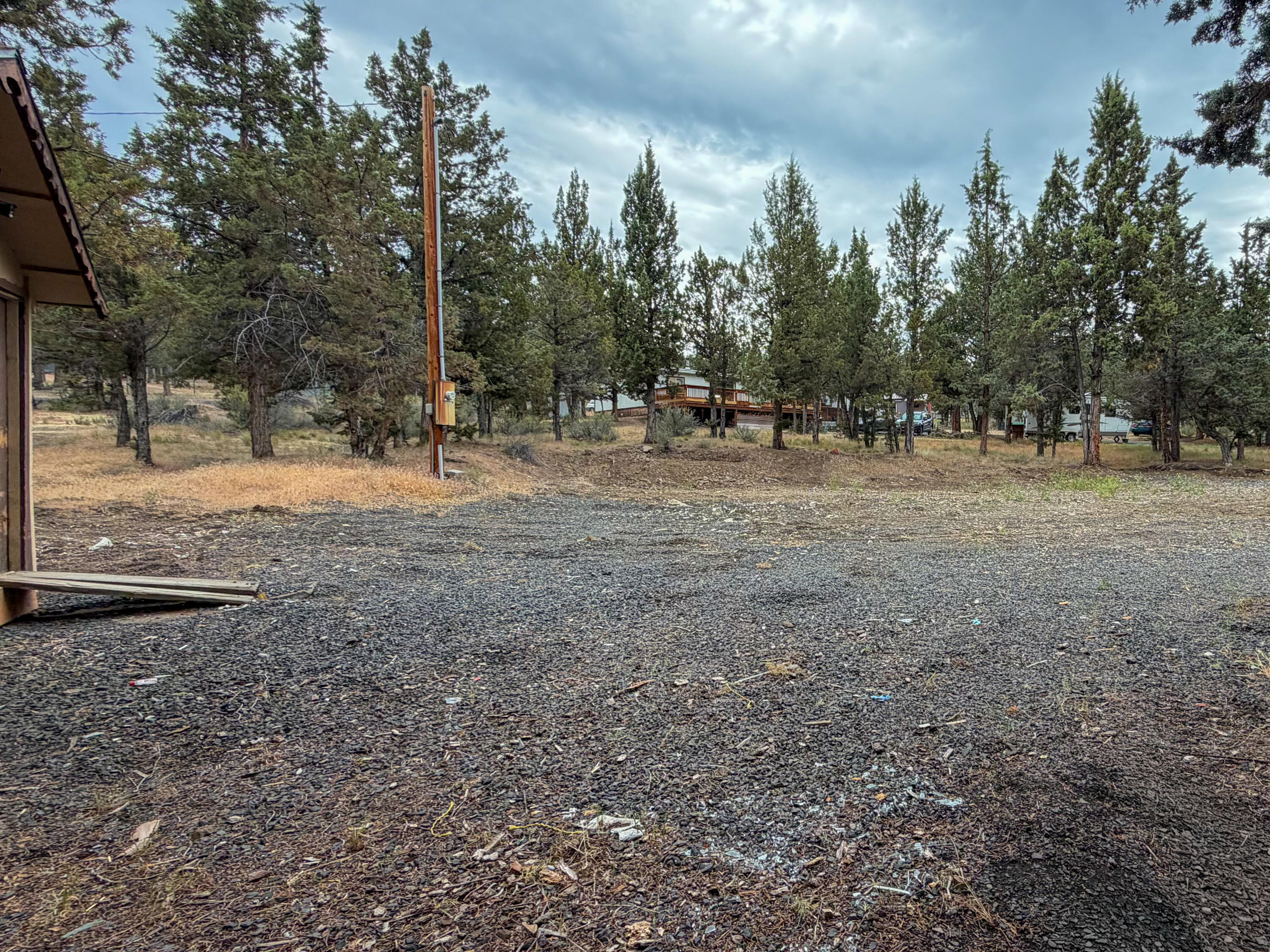 14375 Southeast Juniper Canyon Road Prineville, OR 97754 - Photo 7 of 10 a view of dirt yard with trees