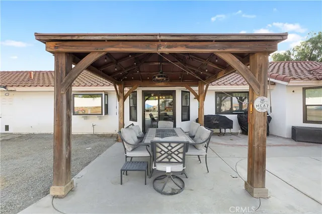 a large white kitchen with stainless steel appliances granite countertop a lot of counter space and a large window