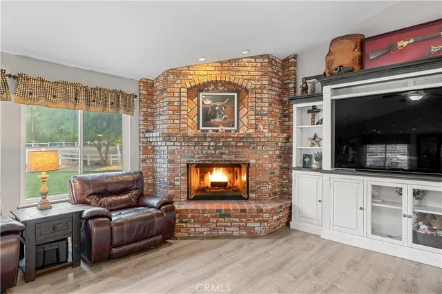 a view of a kitchen with wooden floor and electronic appliances