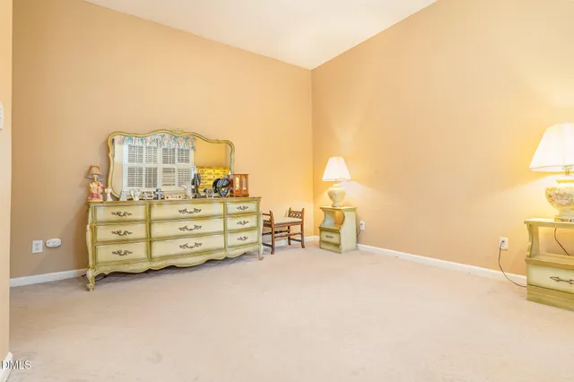 an empty room with a cabinet and mirrors