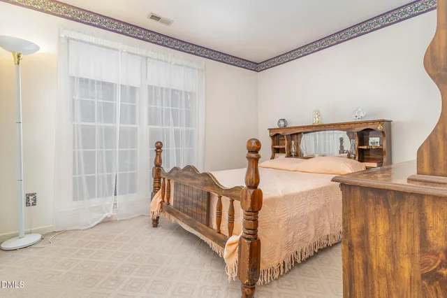 a bedroom with furniture and a mirror