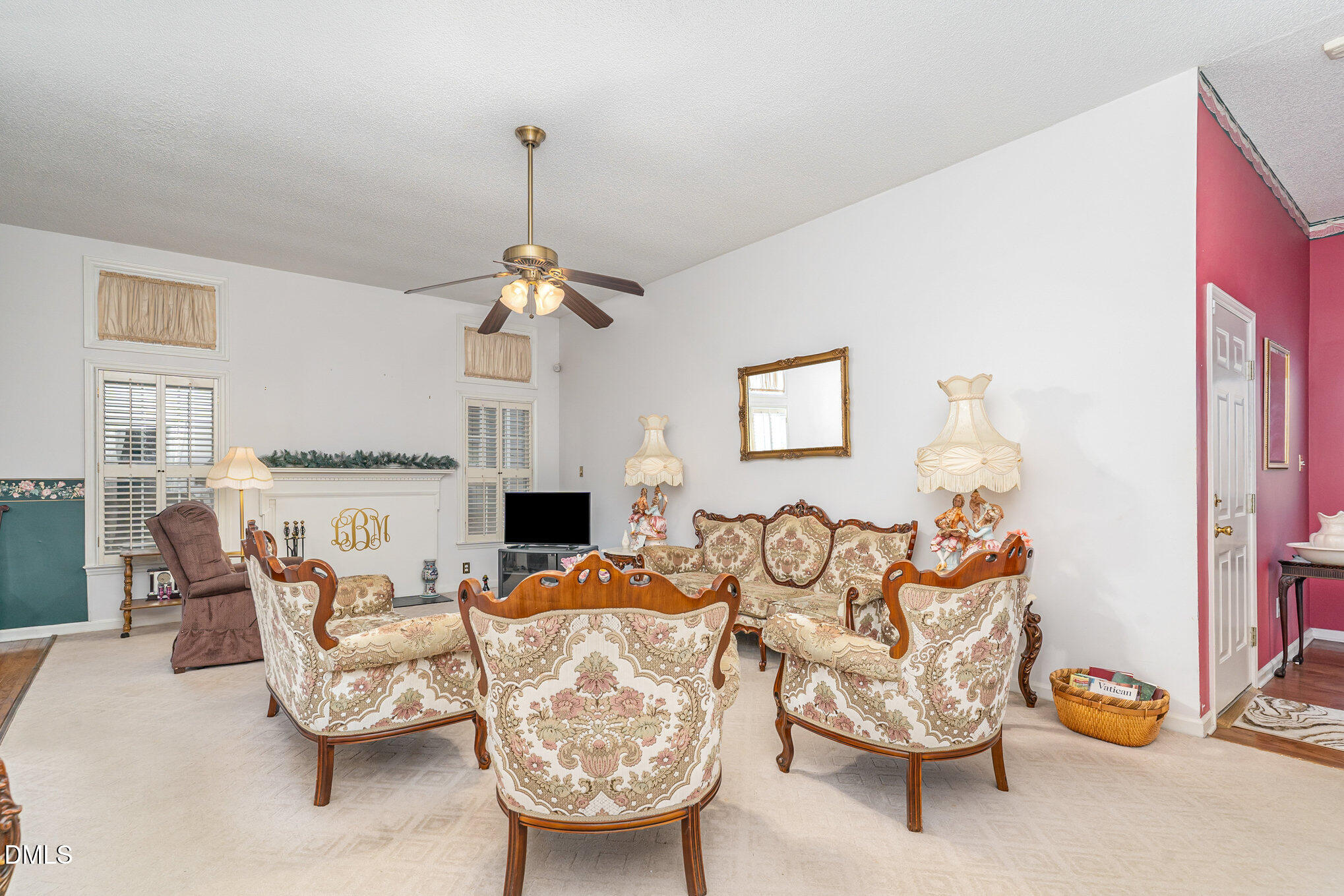 1009 Willow Ridge Drive Knightdale, NC 27545 - Photo 7 of 28 a living room with furniture a fireplace and a chandelier