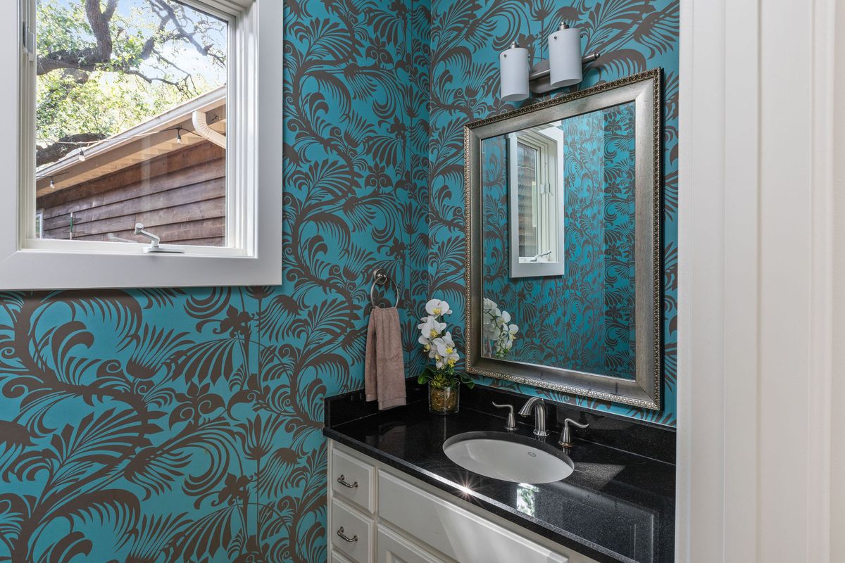 2308 West 9th Street, Unit B Austin, TX 78703 - Photo 20 of 40 a bathroom with a granite countertop sink and a mirror