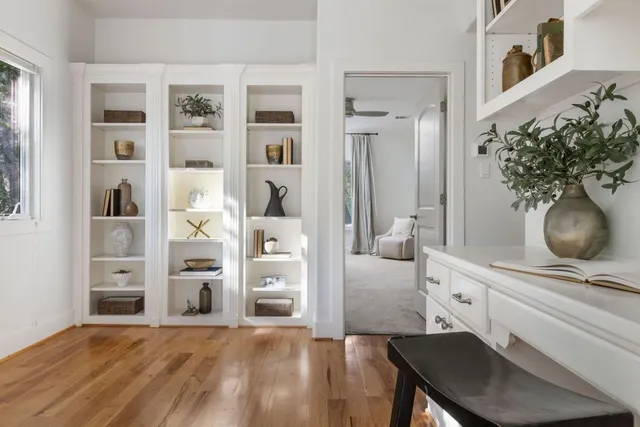 a living room with furniture and flowers