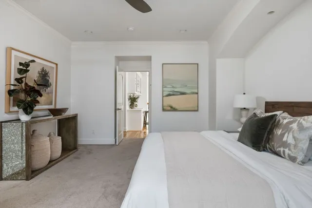 a bedroom with a bed and a painting on the wall