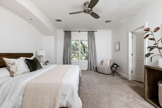 a bedroom with a bed a couch and a window