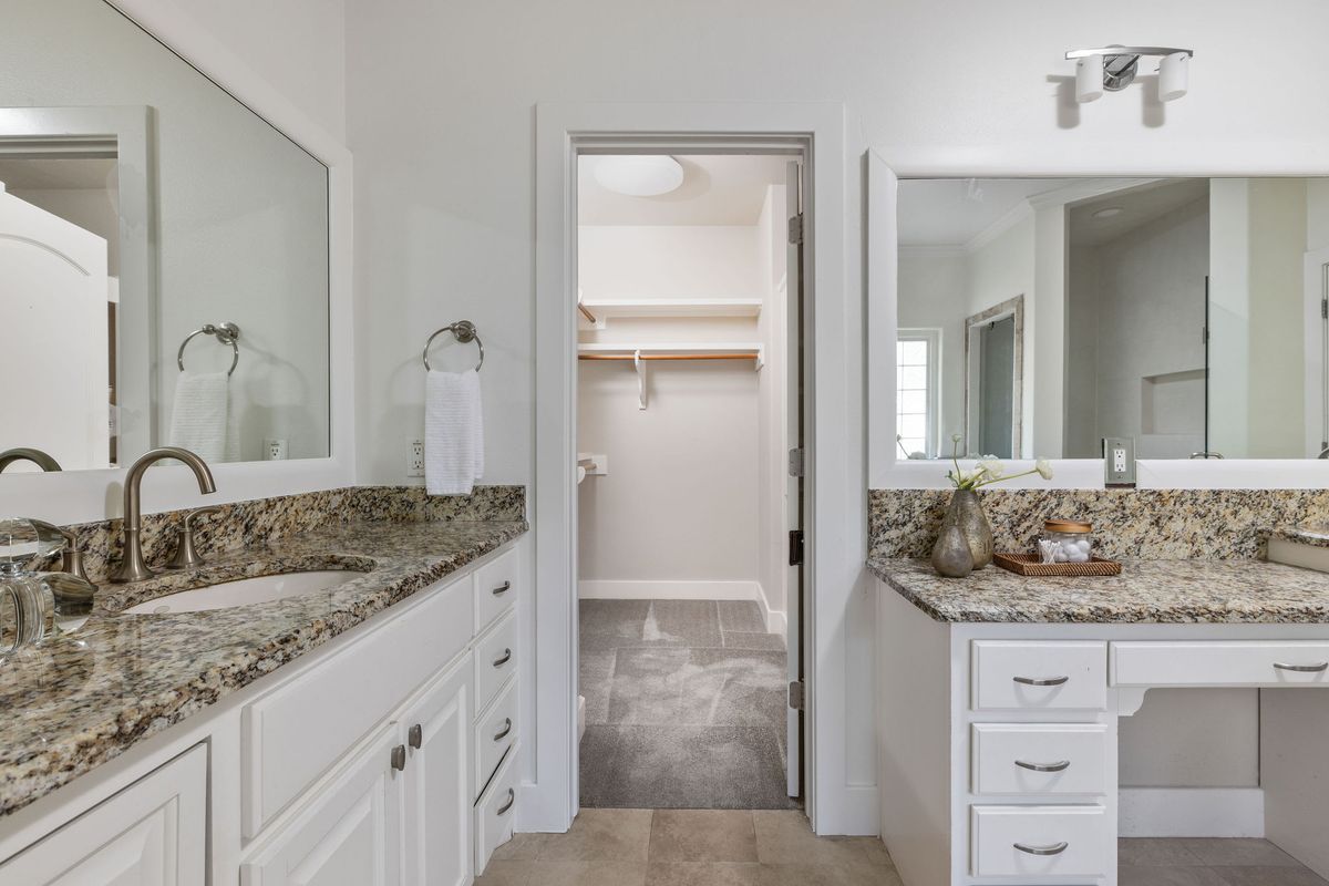 2308 West 9th Street, Unit B Austin, TX 78703 - Photo 31 of 40 a bathroom with a granite countertop sink and a mirror