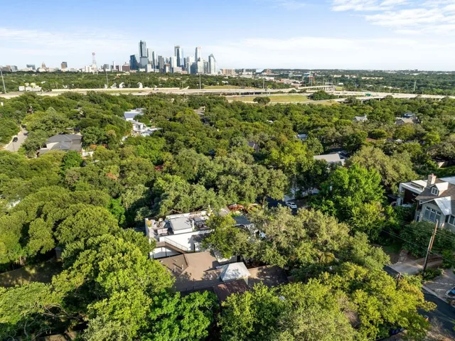 a view of a city with lush green forest
