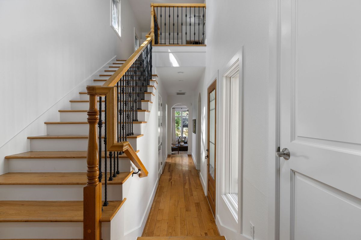 2308 West 9th Street, Unit B Austin, TX 78703 - Photo 6 of 40 a view of a hallway with wooden floor and staircase