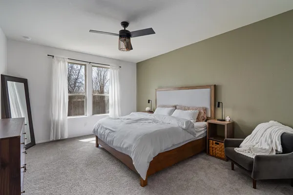 a spacious bedroom with a bed and a couch