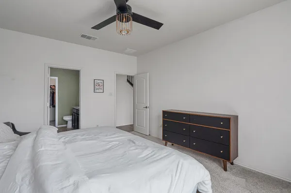 a bedroom with a bed and a dresser