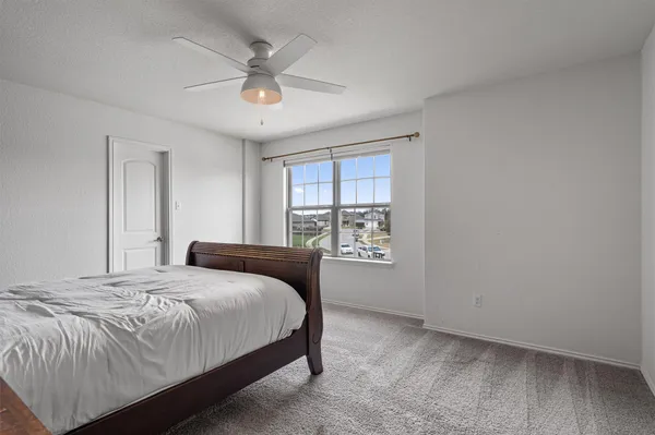 a bedroom with a bed and window