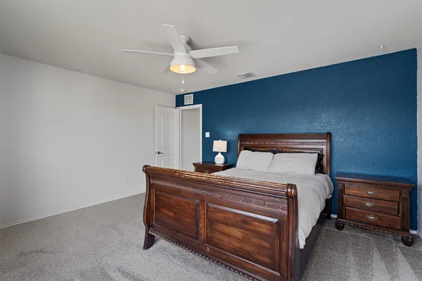 a bedroom with a bed and a chandelier